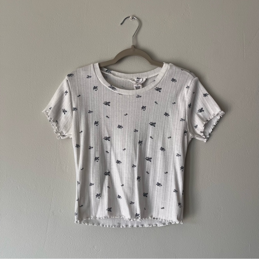White top with blue floral print